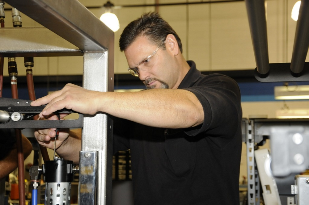A BW Packaging technician working on a machine.