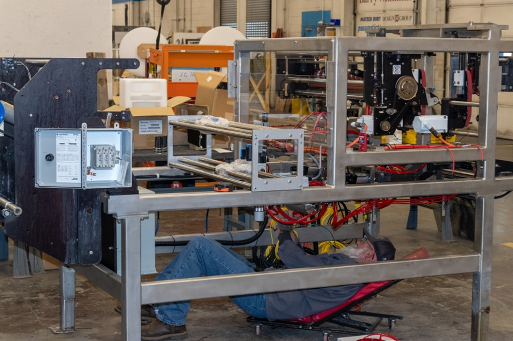 A BW Packaging team member builds an Ultima VFFS bagger