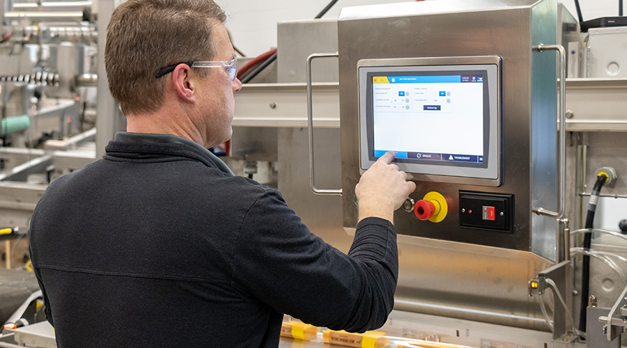 Man interacting with the HMI on the Hayssen X850 Flow Wrapper